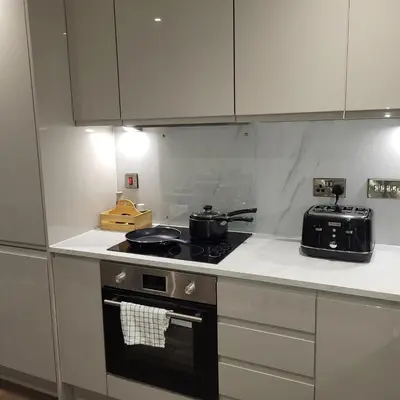 a kitchen with a stove with pots and pans on it at Riverside Apartment in Moffat