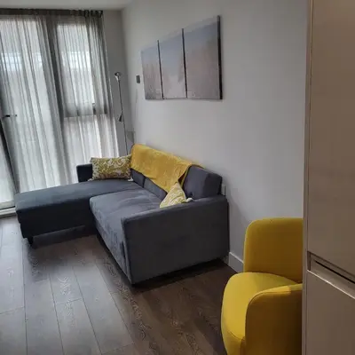 a living room with a couch and a chair at Riverside Apartment in Moffat