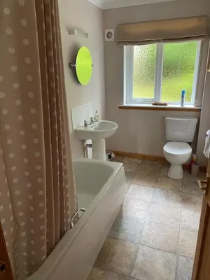 a bathroom with a tub and a toilet and a sink at Spacious holiday home with stunning sea views in Whiting Bay