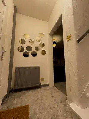 a hallway with plates on the wall of a room at Cozy corner-Sleeps 8 guest Entire house Glasgow very central in Glasgow