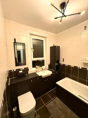 a bathroom with a toilet and a sink and a tub at Cozy corner-Sleeps 8 guest Entire house Glasgow very central in Glasgow