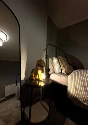a bedroom with a bed and a table with a lamp at Cozy corner-Sleeps 8 guest Entire house Glasgow very central in Glasgow