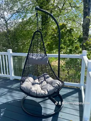 a swing on a porch with pillows at Wemyss Bay Mapleton Elite in Wemyss Bay