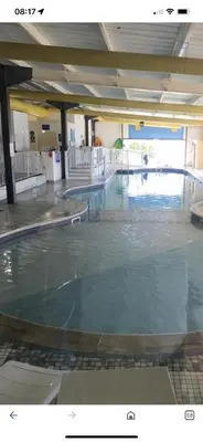 a large swimming pool with blue water in a building at Wemyss Bay Mapleton Elite in Wemyss Bay
