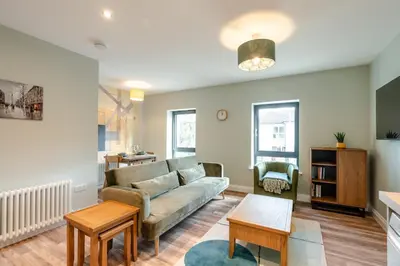 a living room with a couch and a table at Stunning upper villa stay in the City! in Edinburgh