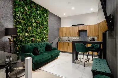 a living room with a green wall at Stylish Edinburgh Apartment in Edinburgh