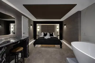 a bedroom with a bed and a bath tub at Stylish Edinburgh Apartment in Edinburgh