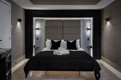 a bedroom with a large bed with a large headboard at Stylish Edinburgh Apartment in Edinburgh