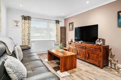a living room with a couch and a flat screen tv at Charming 2BR Oban Home - Quiet area with free parking in Oban
