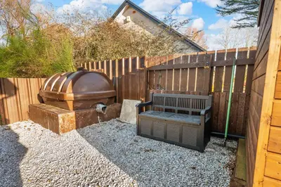 a bench sitting next to a wooden fence at Charming 2BR Oban Home - Quiet area with free parking in Oban