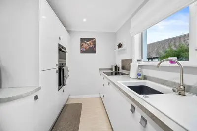 a white kitchen with a sink and a window at Charming 2BR Oban Home - Quiet area with free parking in Oban