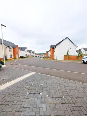 an empty street with houses on the side of the road at YSquared studio in Falkirk