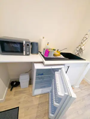 a kitchen counter with a microwave and a sink at YSquared studio in Falkirk