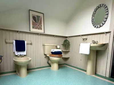 a bathroom with a toilet and a sink at Upstairs at Carlingford in Newton Mearns