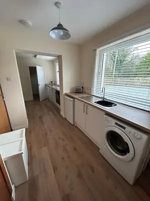 a kitchen with a washer and dryer in a room at Tigh-Na-Croit in Whitehouse