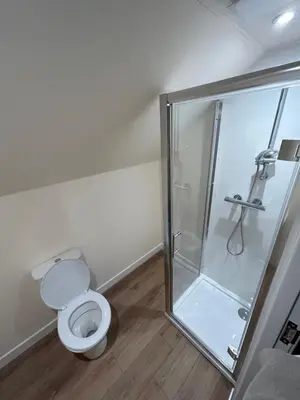 a bathroom with a toilet and a glass shower at Tigh-Na-Croit in Whitehouse