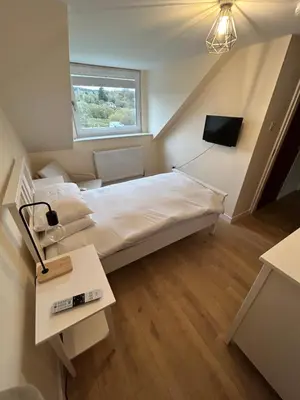 a small bedroom with a bed and a window at Tigh-Na-Croit in Whitehouse