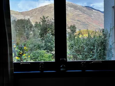 a window with a view of a mountain view at The Cottage at Craigavon House in Ballachulish