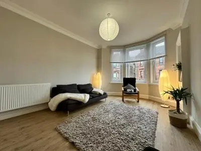 a living room with a couch and a chair at Appin Apartments - Welcome to a delightful and cozy one bedroom flat in Glasgow