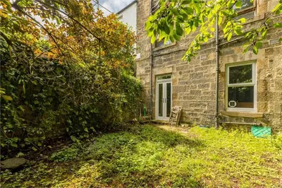 an old brick building with a window and a yard at 3 Bedrooms Flat in Central Edinburgh New Town , Lothian Road in Edinburgh