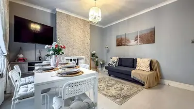a living room with a table and a couch at Quite and new Glasgow house, Commore Drive in Drumchapel