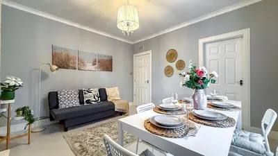 a living room with a table and a couch at Quite and new Glasgow house, Commore Drive in Drumchapel