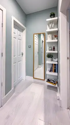 a hallway with a mirror and a door at Quite and new Glasgow house, Commore Drive in Drumchapel