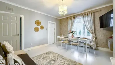 a dining room with a table and chairs and a window at Quite and new Glasgow house, Commore Drive in Drumchapel