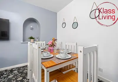 a dining room with a table and chairs at Lady Wilson Apartment by Klass Living Airdrie in Airdrie