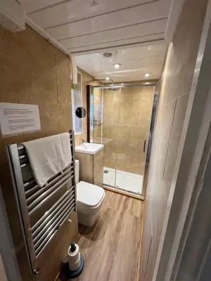 a small bathroom with a toilet and a shower at Old Brewery Cottage - Ellenabeich, Easdale - Isle of Seil