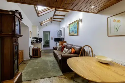 a living room with a couch and a table at Old Brewery Cottage - Ellenabeich, Easdale - Isle of Seil