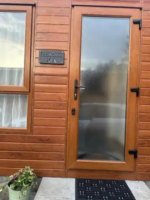 a door to a building with a sign on it at Glen-coo in Auchterarder