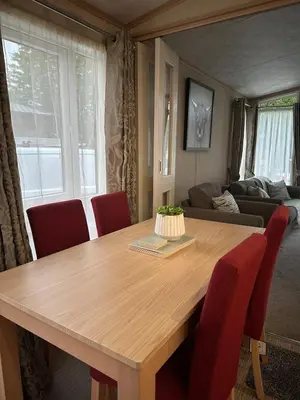 a dining room table with a cake on top of it at Glen-coo in Auchterarder