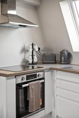 a kitchen with a stove and a counter top at Large Edinburgh Studio - Close to City Centre, Murrayfield and Airport in Edinburgh