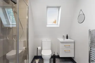 a bathroom with a toilet and a sink and a shower at Large Edinburgh Studio - Close to City Centre, Murrayfield and Airport in Edinburgh