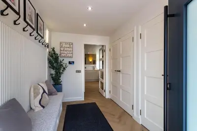 a hallway with a door leading to a living room at The Shore House in Lamlash