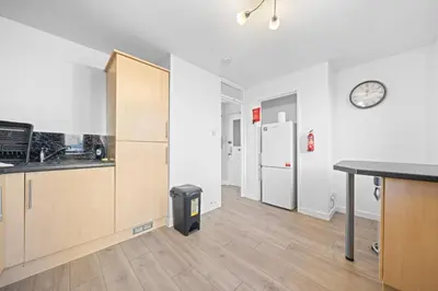 a kitchen with a counter and a clock on the wall at Lauriston 1 Bedroom Apartment - Edinburgh in Edinburgh