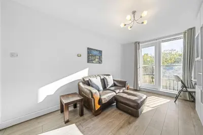a living room with a couch and a chair and a window at Lauriston 1 Bedroom Apartment - Edinburgh in Edinburgh