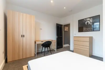 a bedroom with a desk and a bed and a desk at Faulkner Luxury Suites in Moffat