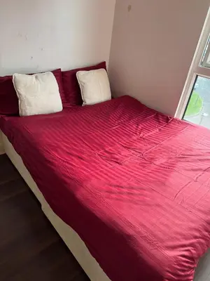 a large red bed with two pillows in a room at Charming Edinburgh Apartment with Electric Heating Free WiFi in Edinburgh