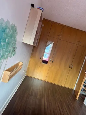 a room with wooden cabinets and a window at Charming Edinburgh Apartment with Electric Heating Free WiFi in Edinburgh