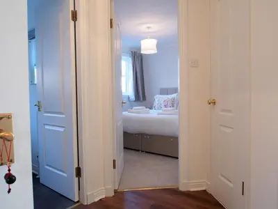 a room with a bedroom with a bed and a window at Fettes - Homely 2BD in Quiet Development in Edinburgh