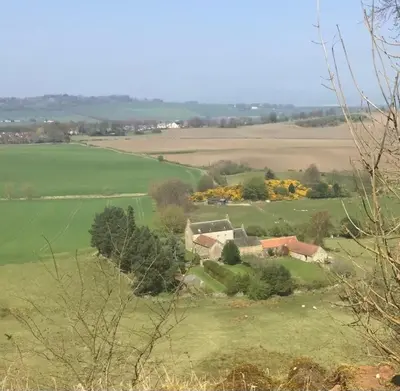 an aerial view of a house in a green field at Linlithgow cottage close to Edinburgh in Linlithgow