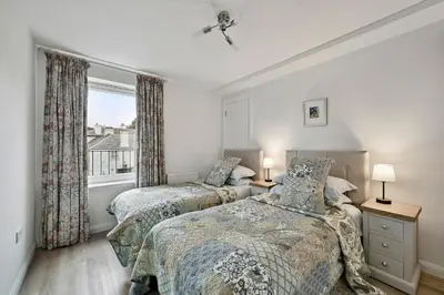 two beds in a bedroom with a window at Finest Retreats - Riverside View in Balloch
