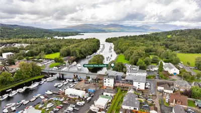 an aerial view of a town next to a river at Finest Retreats - Riverside View in Balloch
