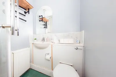 a bathroom with a sink and a toilet at Stylish and Unique Apartment by the Meadows 8 in Edinburgh