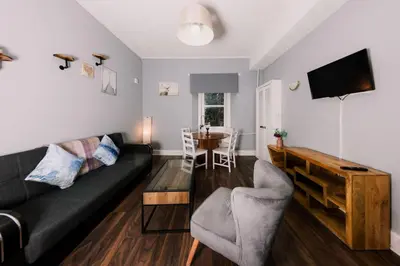 a living room with a couch and a table at Stylish and Unique Apartment by the Meadows 8 in Edinburgh