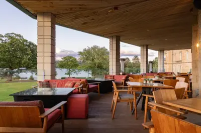 a restaurant with tables and chairs and a large window at 2 Bedroom detached lodge overlooking Loch Lomond in Balloch