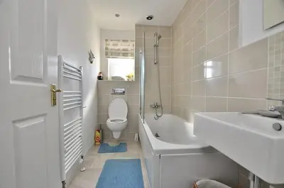 a bathroom with a toilet and a sink and a tub at Westcoast-Retreat-Largs in Largs
