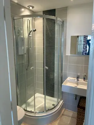 a bathroom with a glass shower and a sink at Westcoast-Retreat-Largs in Largs